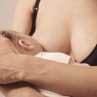 Close up image of woman nursing her child , wearing the Semiromantic Olivia nursing bra