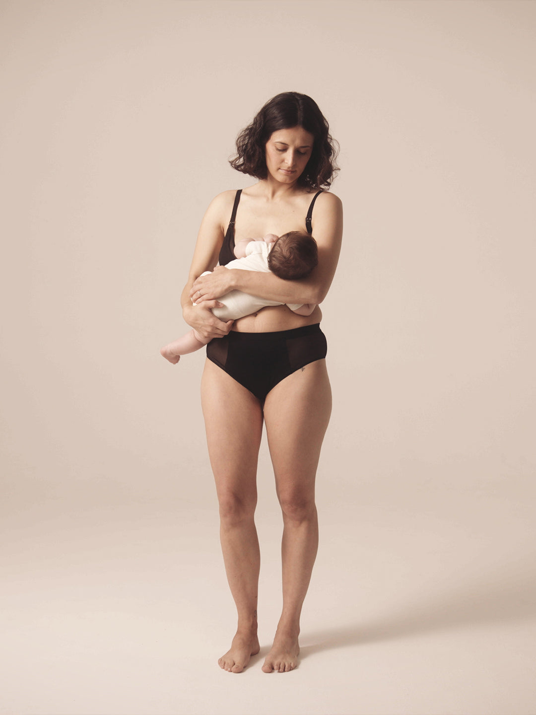 Woman nursing her child. She is wearing the Semiromantic Olivia nursing bran and Olivia Pantie