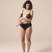 Woman nursing her child. She is wearing the Semiromantic Olivia nursing bran and Olivia Pantie