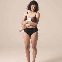 Woman nursing her child. She is wearing the Semiromantic Olivia nursing bran and Olivia Pantie