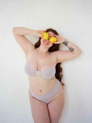 Model wearing Bea underwire bra in colour Mist and Esme thong in colour Mist