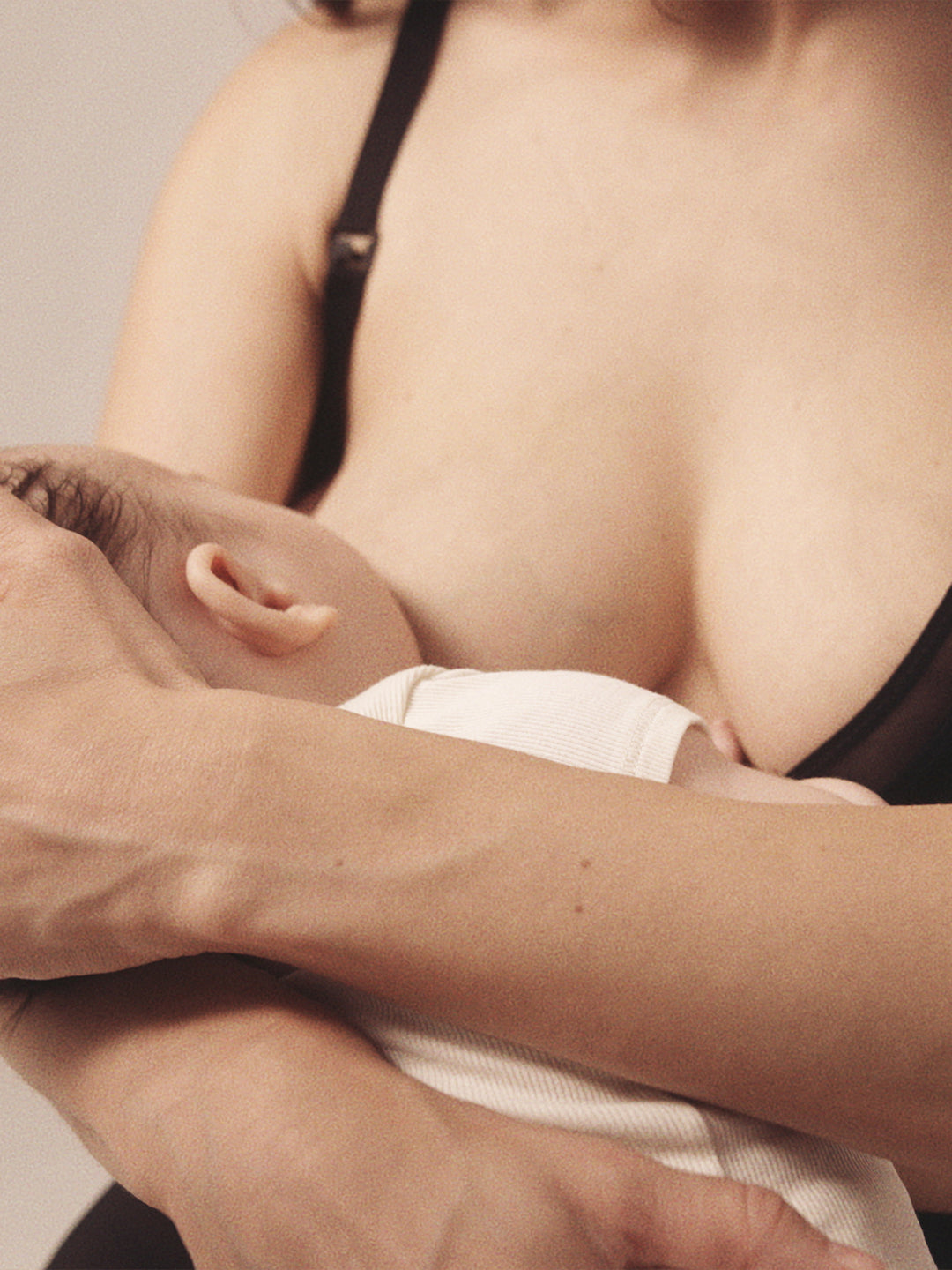 Close up image of woman nursing her child , wearing the Semiromantic Olivia nursing bra