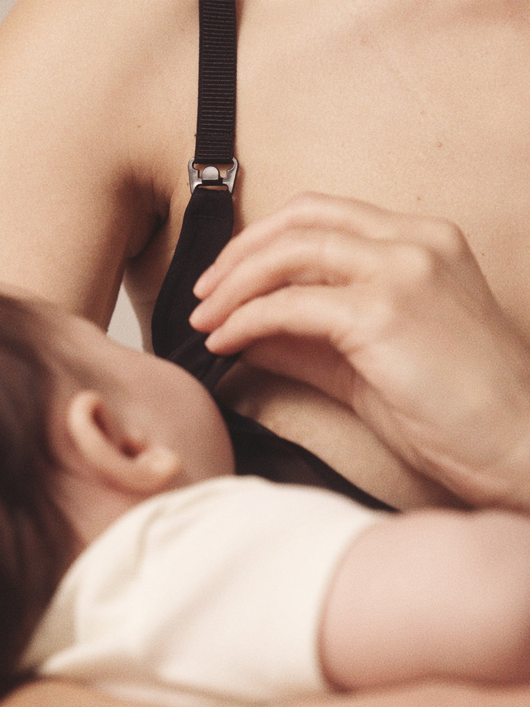 Close up of woman unclasping a nursing bra to nurse her child to